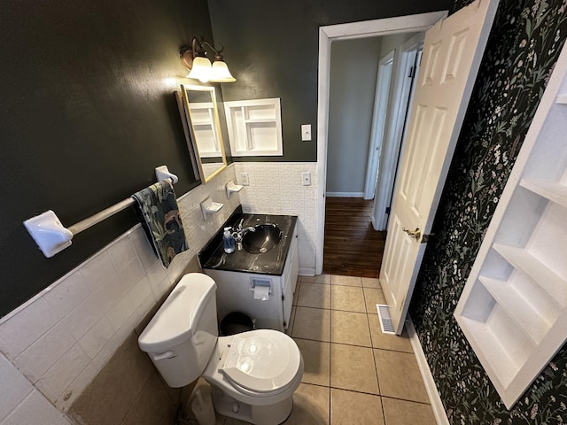 bathroom featuring tile patterned flooring, vanity, and toilet