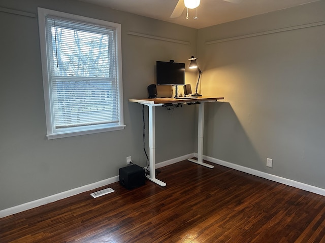 unfurnished office featuring ceiling fan and dark hardwood / wood-style floors