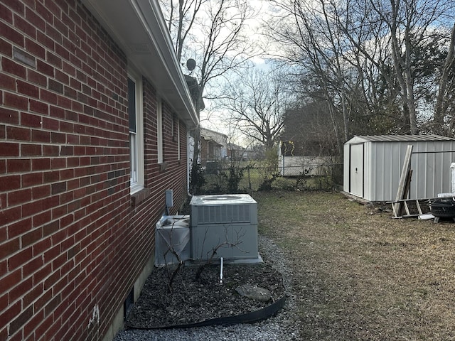 view of yard with cooling unit and a shed