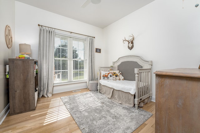 bedroom with ceiling fan and light wood-type flooring