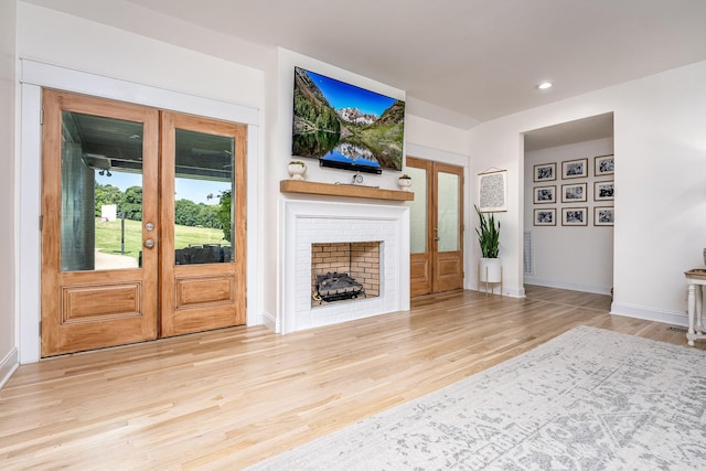 living room featuring light hardwood / wood-style flooring and french doors