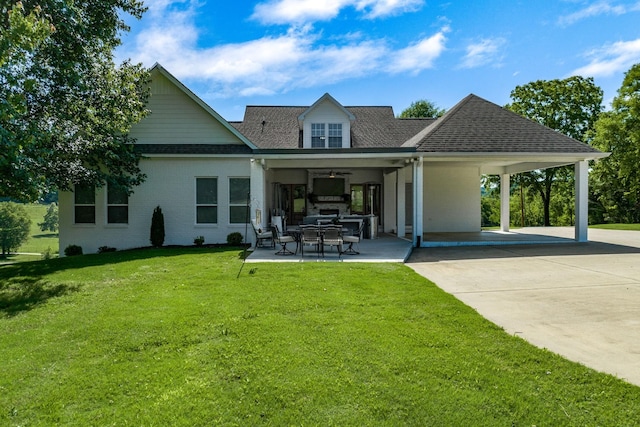 rear view of property with a carport and a yard