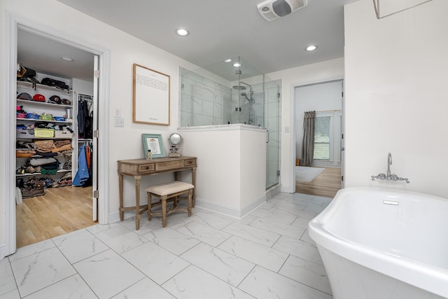 bathroom with separate shower and tub