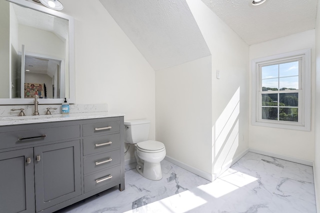 bathroom with vanity, toilet, and a textured ceiling