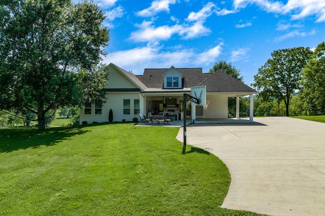 rear view of property featuring a patio area and a lawn