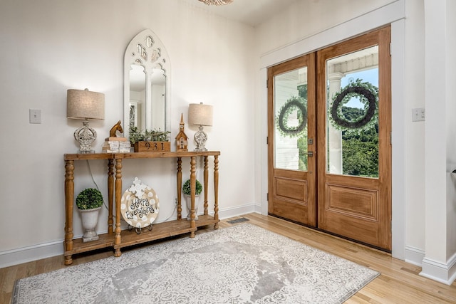 foyer entrance featuring wood-type flooring and french doors