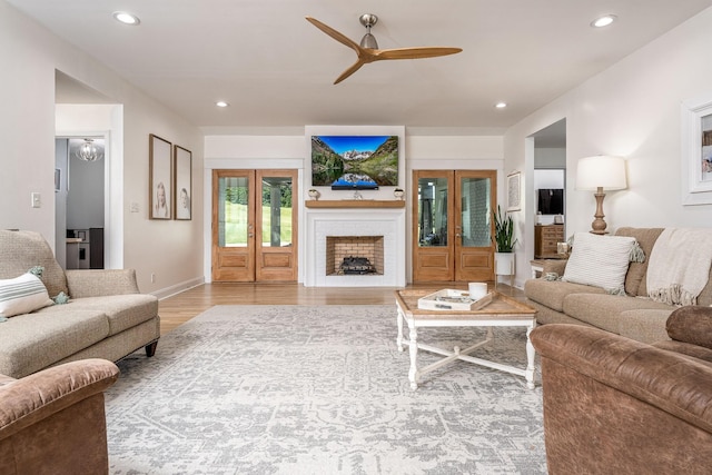 living room with hardwood / wood-style floors and ceiling fan