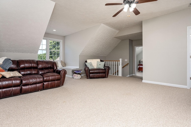 living room with carpet flooring, a textured ceiling, vaulted ceiling, and ceiling fan