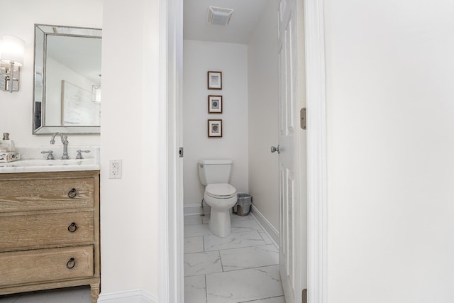 bathroom with vanity and toilet