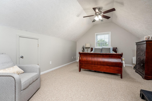 bedroom featuring carpet flooring, ceiling fan, lofted ceiling, and a textured ceiling