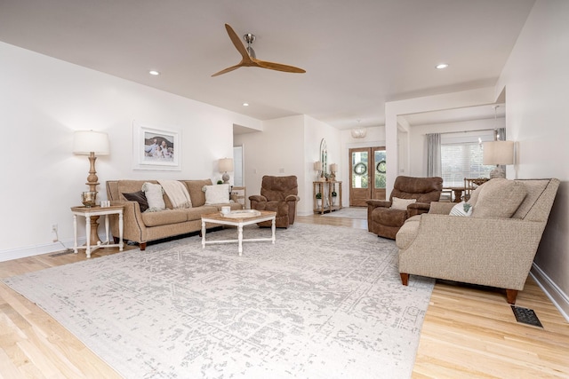 living room featuring french doors, hardwood / wood-style flooring, and ceiling fan