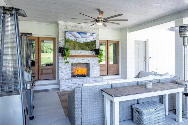 view of patio / terrace with ceiling fan, french doors, and an outdoor brick fireplace