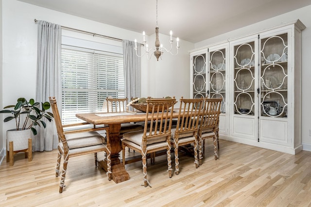 dining space with a chandelier and light hardwood / wood-style floors