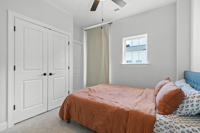 bedroom featuring a closet, ceiling fan, and light colored carpet