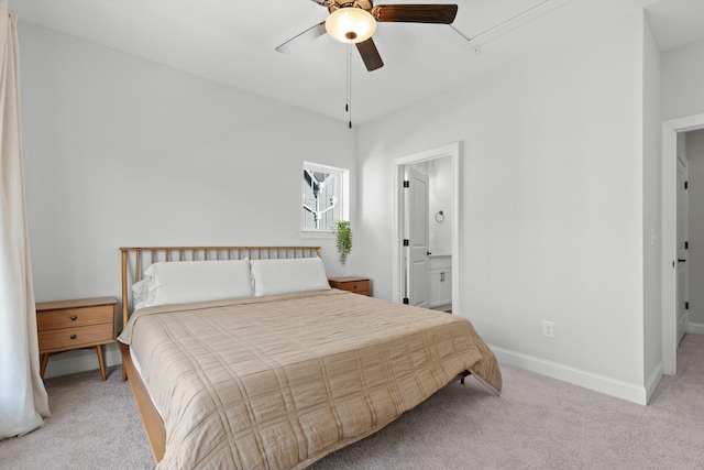 bedroom with light colored carpet, ceiling fan, and ensuite bathroom