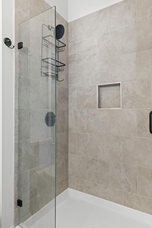 bathroom with a shower with shower door