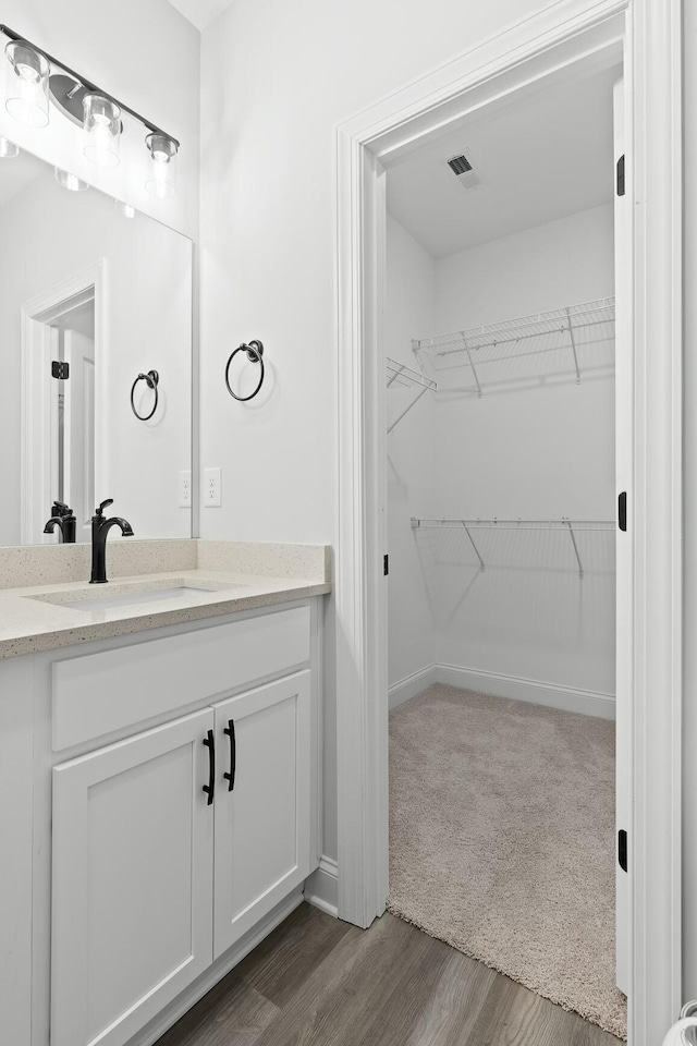 bathroom with hardwood / wood-style floors and vanity