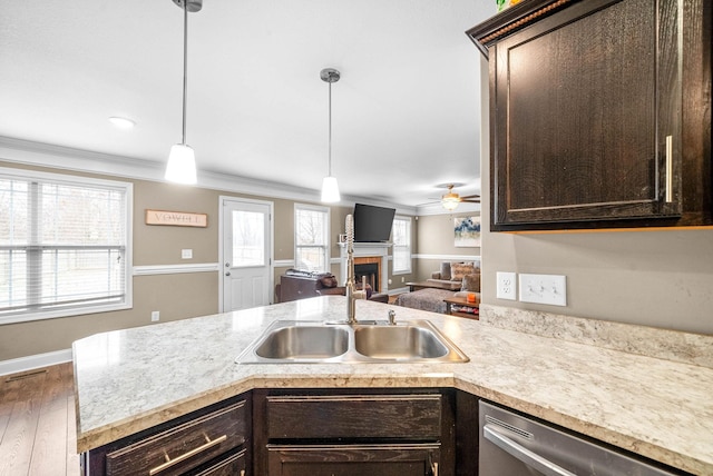 kitchen featuring a wealth of natural light, dishwasher, hanging light fixtures, and sink