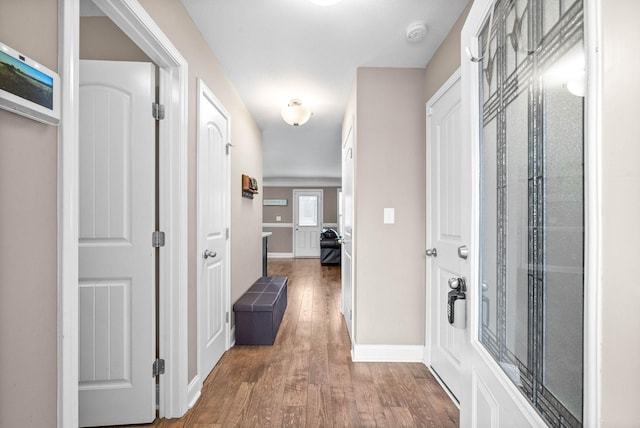 hall with hardwood / wood-style floors