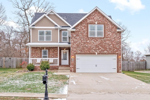 view of front of home with covered porch, a garage, and a front lawn