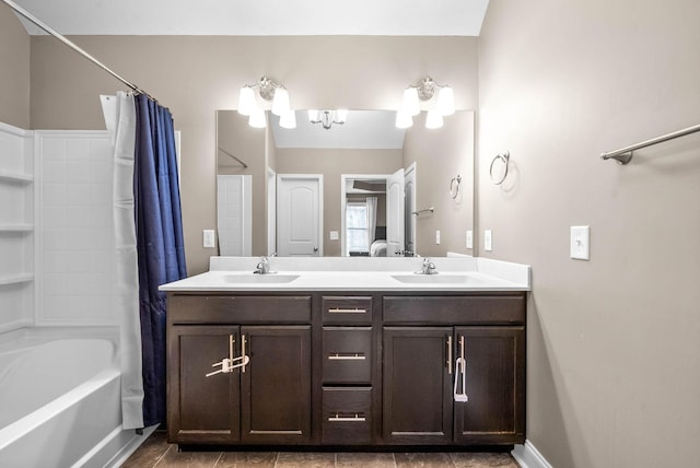 bathroom with shower / bath combo with shower curtain and vanity