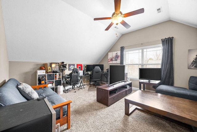 carpeted living room with ceiling fan and vaulted ceiling