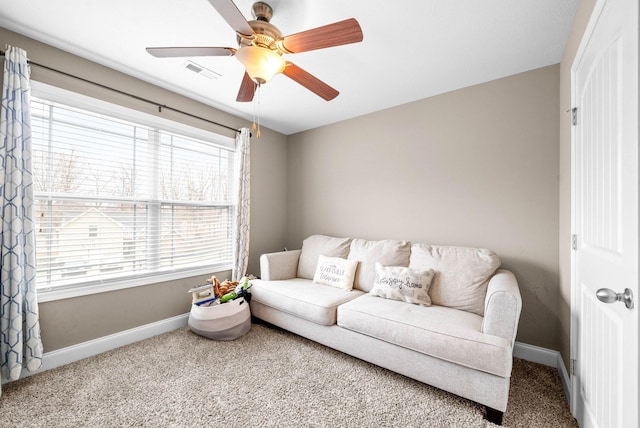 carpeted living room featuring ceiling fan