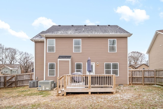 back of property with a wooden deck and central AC