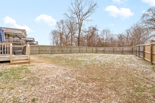 view of yard featuring ceiling fan and a wooden deck