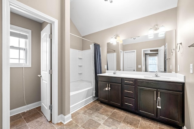 bathroom featuring shower / bath combination with curtain, vanity, and lofted ceiling