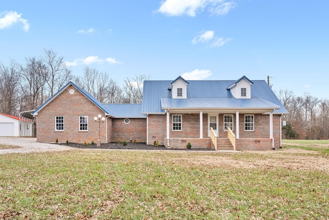 view of front of property with a front lawn, covered porch, an outdoor structure, and a garage