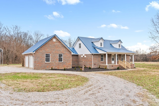 view of front facade with a front yard, a porch, and a garage