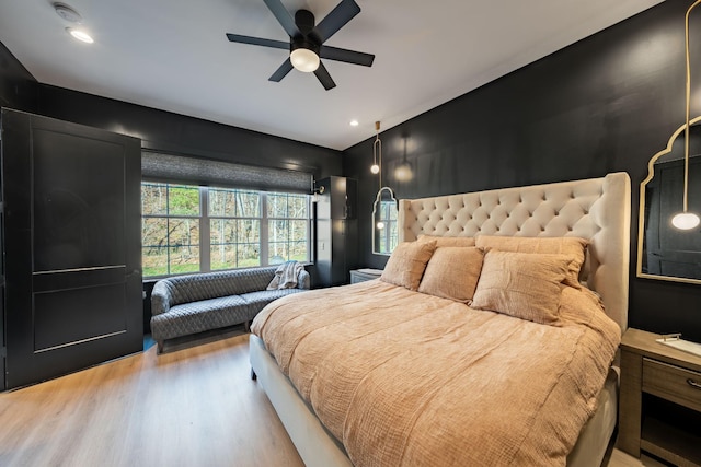 bedroom featuring ceiling fan and light hardwood / wood-style flooring