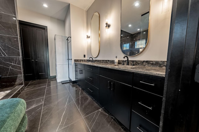 bathroom with walk in shower and vanity