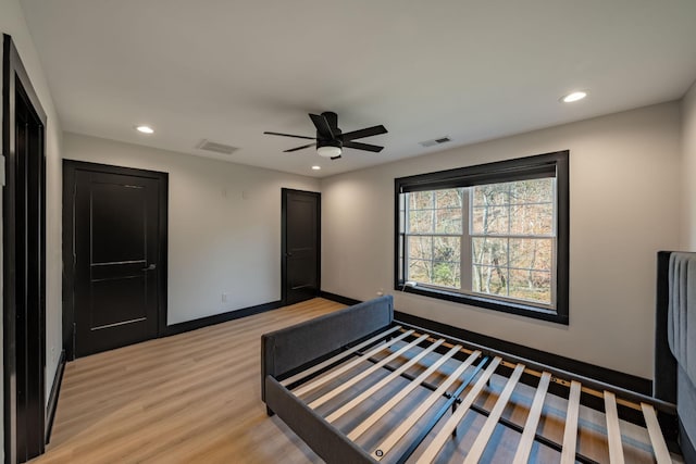 unfurnished bedroom with ceiling fan and light hardwood / wood-style floors