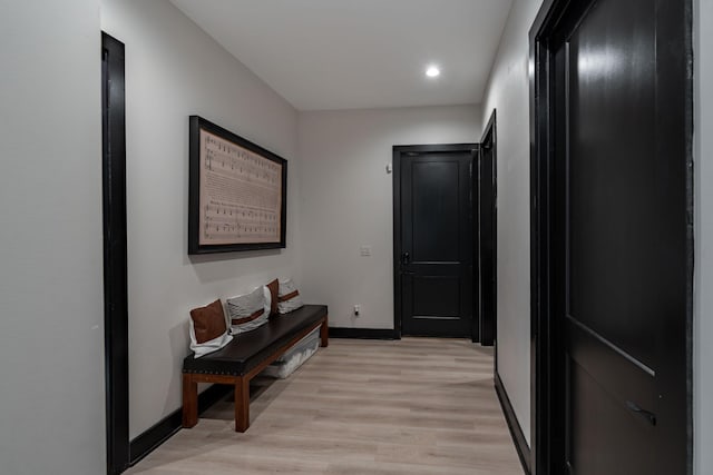 hallway with light hardwood / wood-style flooring