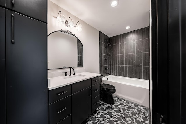 full bathroom featuring toilet, vanity, and tiled shower / bath combo