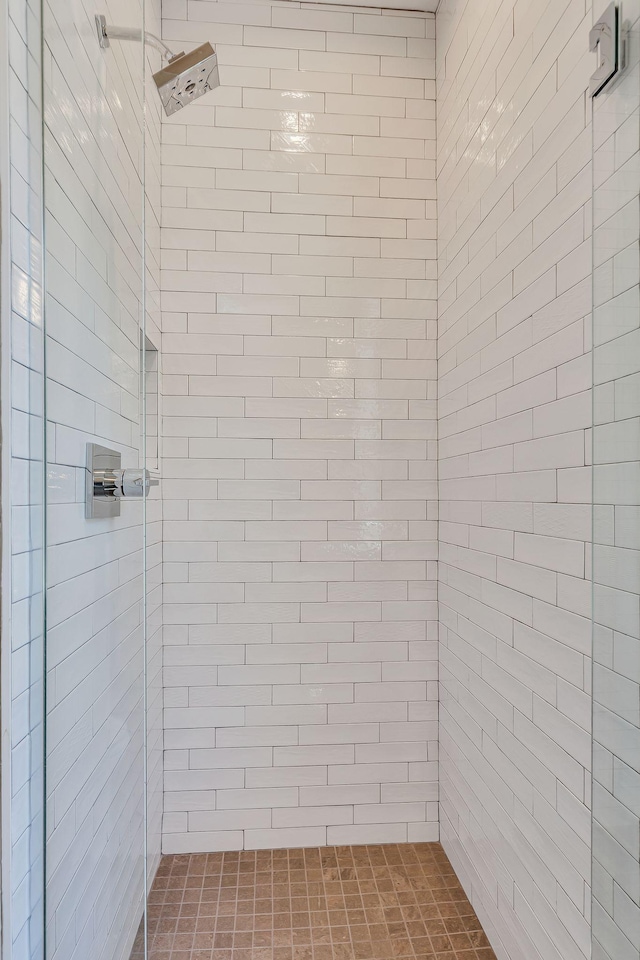 bathroom with a tile shower