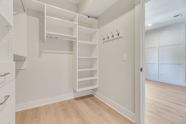 spacious closet with light hardwood / wood-style floors