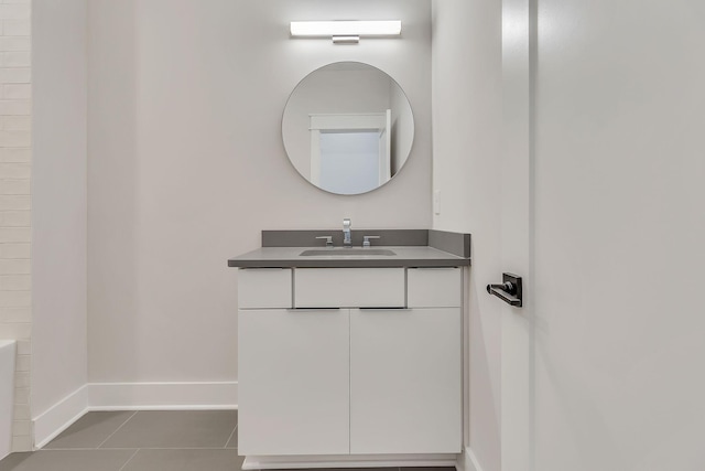 full bathroom with tile patterned flooring, vanity, and baseboards