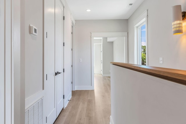 hallway featuring recessed lighting, baseboards, visible vents, and light wood finished floors