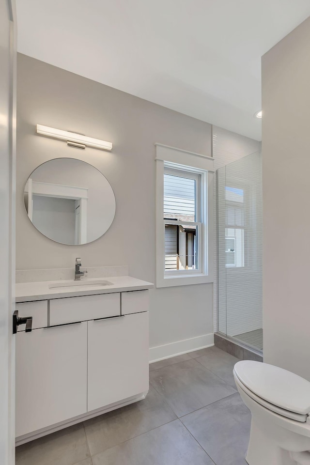 bathroom featuring vanity, a shower with shower door, and toilet