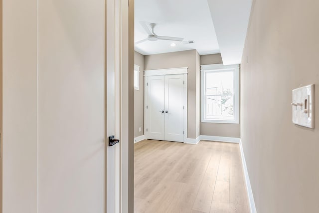 corridor with light wood-type flooring