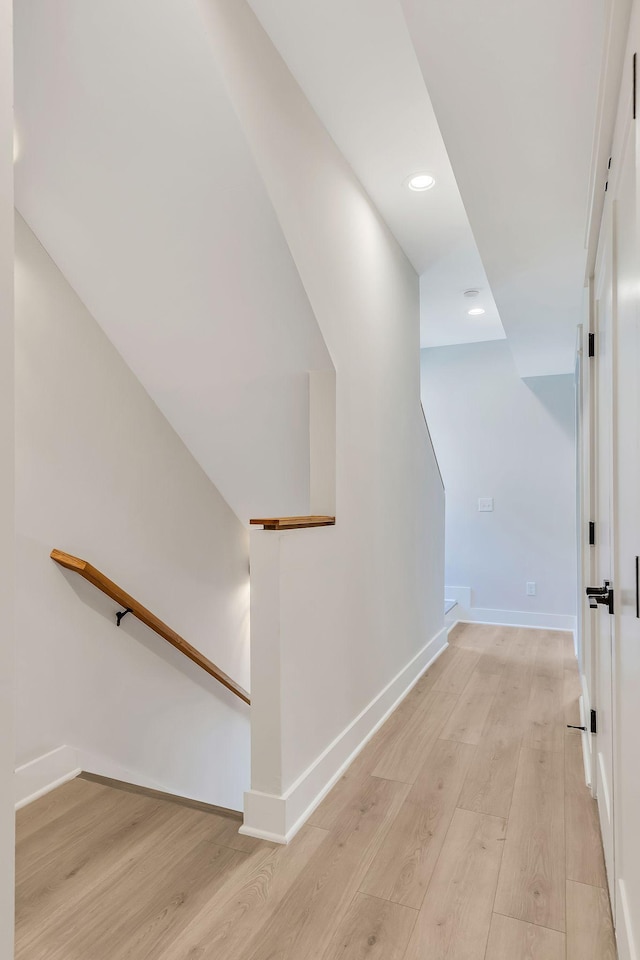 stairway with recessed lighting, wood finished floors, and baseboards