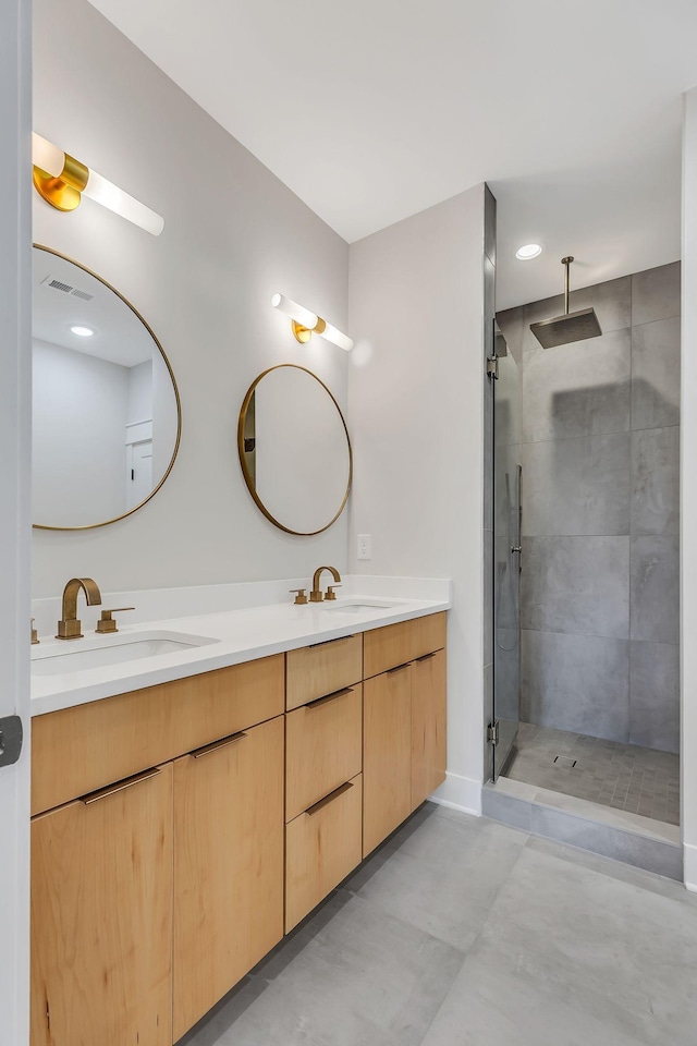 bathroom featuring a sink, visible vents, a stall shower, and double vanity