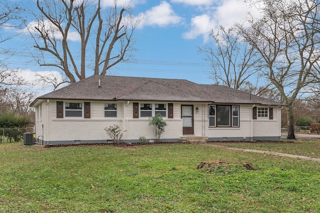 ranch-style home featuring a front lawn and central air condition unit