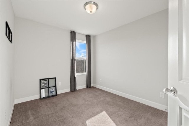 unfurnished room featuring dark carpet