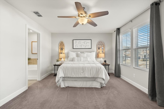 bedroom with carpet, connected bathroom, and ceiling fan