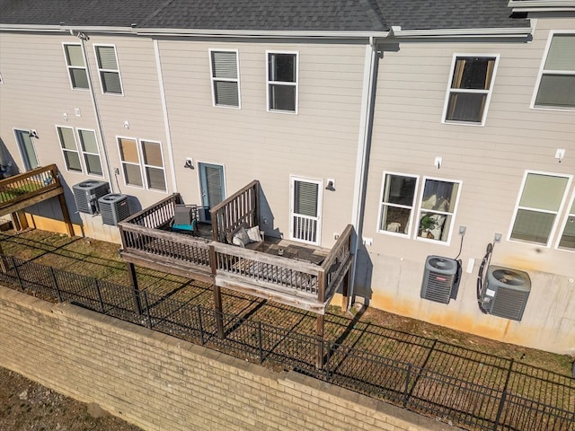 rear view of property with central AC and outdoor lounge area