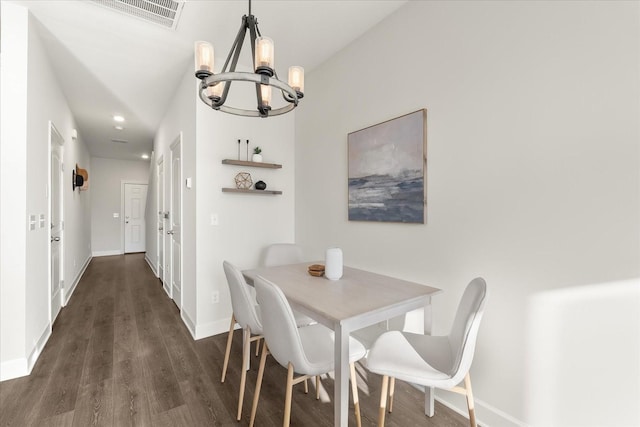 dining area featuring dark hardwood / wood-style floors and a notable chandelier